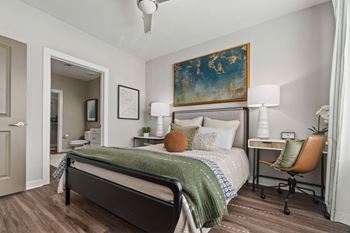 A bedroom with a bed, desk, and chair at 1010 Dilworth Apartments, Charlotte 28204